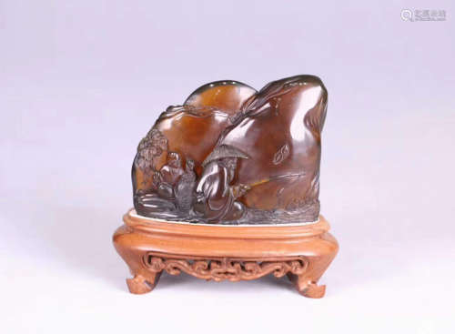 AN OLD AMBER CARVED MOUNTAIN SHAPED PENDANT