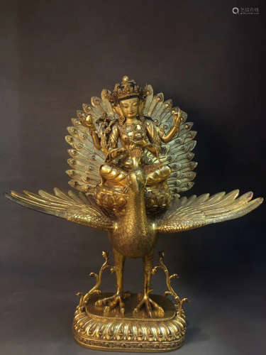 A GILT COPPER PEACOCK GUANYIN BUDDHA