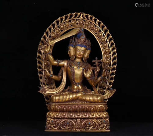 A GILT BRONZE MULTI-ARM MANJUSHRI BUDDHA