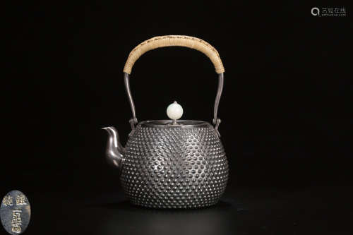 A SILVER CASTED RIVET SHAPED TEAPOT