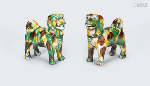 A pair of sancai glazed models of dogs