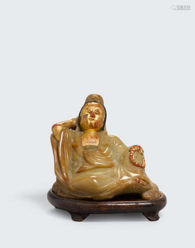 17th/18th century A small polychrome and gilt lacquered soapstone carving of a reclining Guanyin