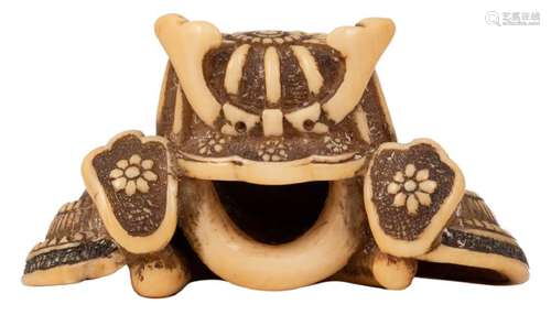 An ivory katabori samurai helmet shaped netsuke, late