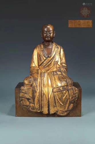 A GILT-BRONZE FIGURE OF SEATED LAMA