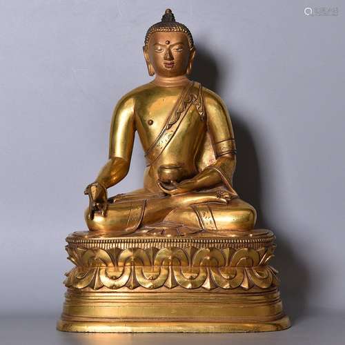 A GILT-BRONZE FIGURE OF MEDICINE BUDDHA