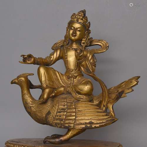 A GILT-BRONZE FIGURE OF BIRD-RIDING BUDDHA