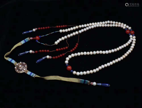 A STRING OF PALACE COURT PEARL BEADS