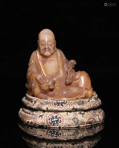 A SOAPSTONE CARVED GEM DECORATED BUDDHA