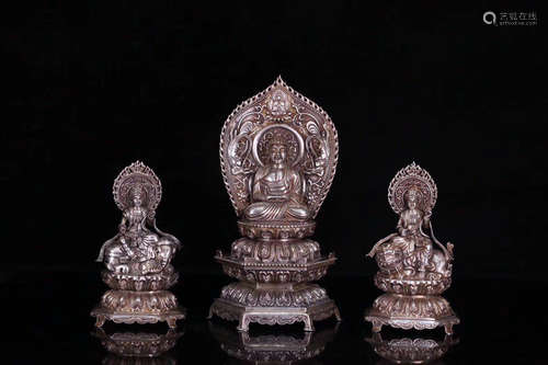 SET OF THREE SILVER MOLDED BUDDHA STATUES