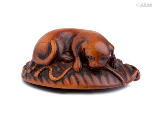 A WOOD NETSUKE OF A DOG AND ABALONE 19th century u...