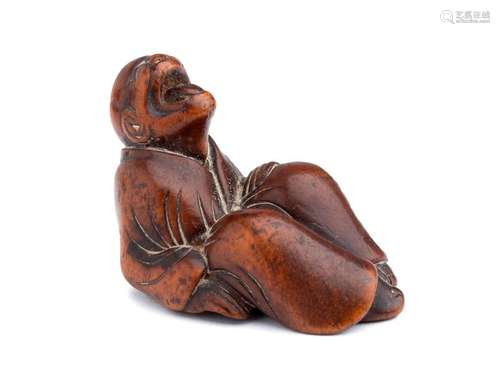 A WOOD NETSUKE OF STRETCHING AND YAWNING DARUMA 19...