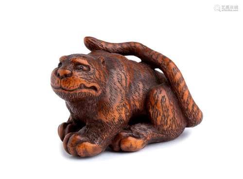 A WOOD NETSUKE OF A TIGER Ise, early 19th century ...