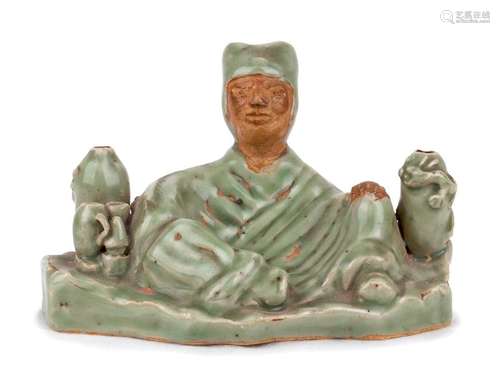 A CÉLADON GLAZED SEATED MONK China, probably Ming ...