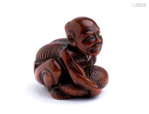 A WOOD NETSUKE OF A MAN WITH DEFORMED TESTICLE sec...