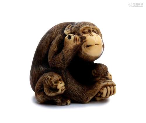 AN IVORY NETSUKE OF A MONKEY AND TWO CUBS second h...