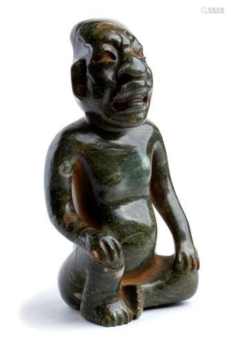 AN GREEN STONE CARVING OF A KNEELING MALE FIGURE O...