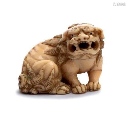 AN IVORY NETSUKE OF A SHISHI first half of the 19t...