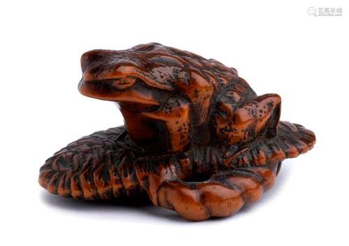 A WOOD NETSUKE OF A TOAD ON A SANDAL Ise, second h...