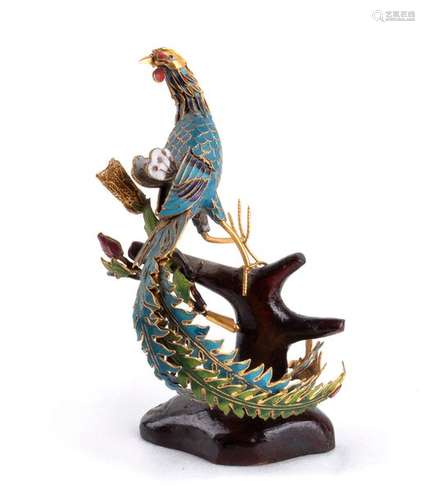 AN ENAMELLED METAL PHOENIX ON A WOODEN PERCH China...