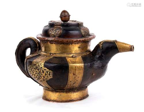 A PARTIALLY GILT COPPER AND BRASS TEAPOT AND COVER...