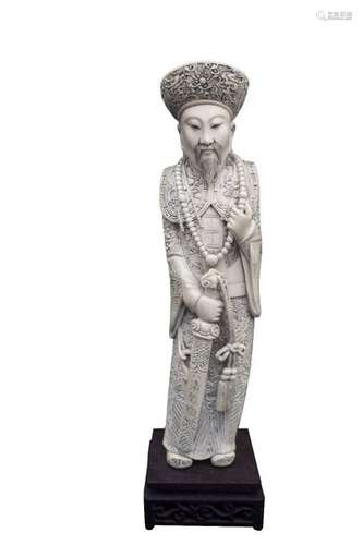 AN IVORY CARVING OF A STANDING DIGNITARY China, ea...