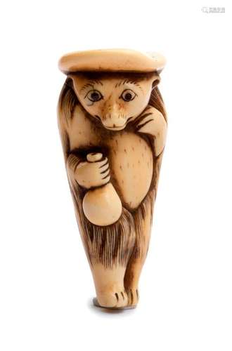 AN IVORY NETSUKE OF A STANDING TANUKI early 19th c...