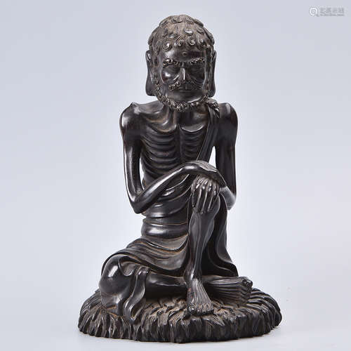 A CARVED ROSEWOOD BUDDHA STATUE