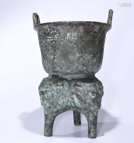 A BRONZE TRIPOD VESSEL