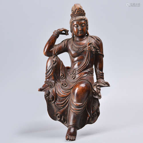 A CARVED ROSEWOOD GUANYIN STATUE