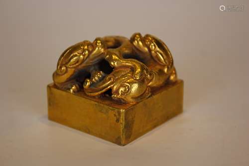 A GILT BRONZE BEAST SEAL