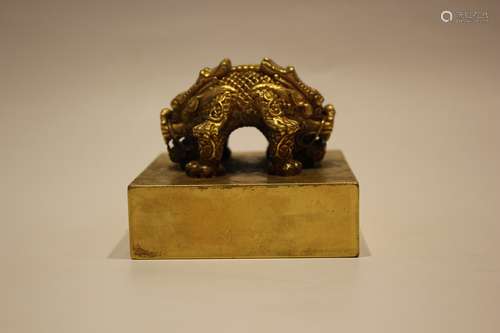 A GILT BRONZE BEAST SEAL