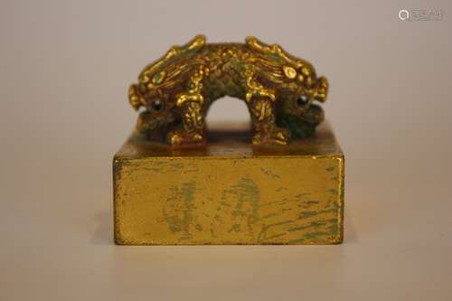 A GILT BRONZE BEAST SEAL