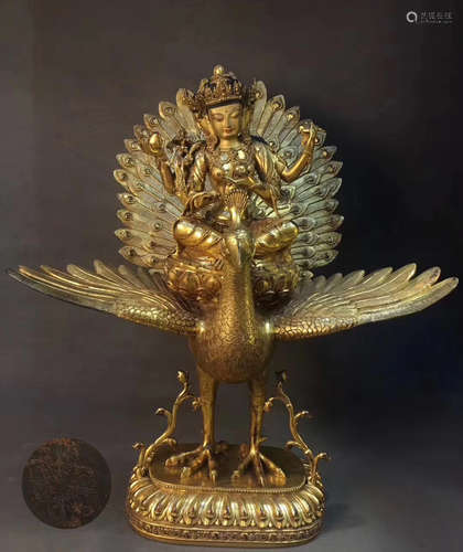 A GILT COPPER PEACOCK GUANYIN BUDDHA