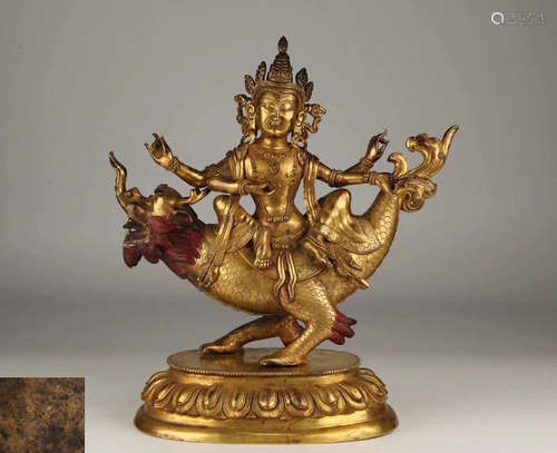 A GILT BRONZE MOLDED FOUR HAND BUDDHA STATUE