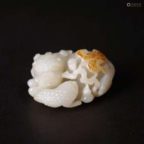 A CARVED RUSSET JADE LION