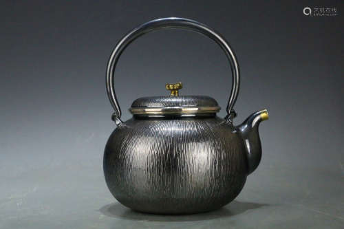 AN OLD SILVER TEAPOT