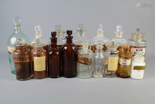 A Miscellaneous Collection of Apothecary Bottles, some clear, some brown a green and a blue, two bottles without stoppers