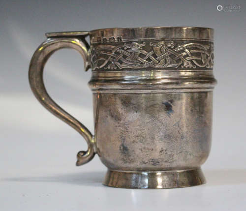 An Edwardian silver christening tankard of cylindrical form, the rim decorated in relief with a