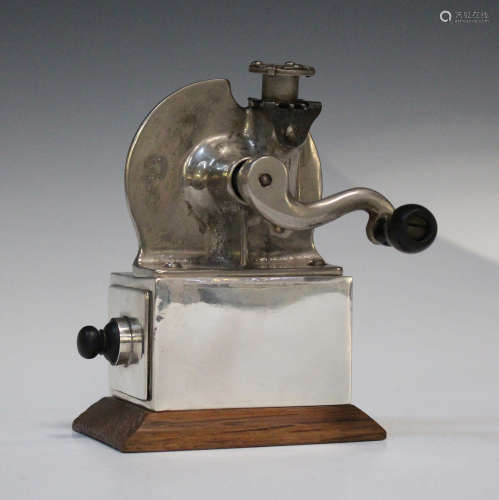 An Edwardian silver mounted pencil sharpener, the steel rotating cutter with three blades, the