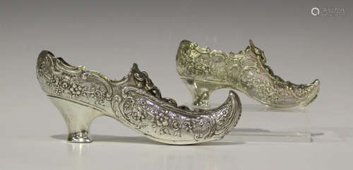 A late 19th century Continental silver shoe, cast with panels of flowers within scroll borders,