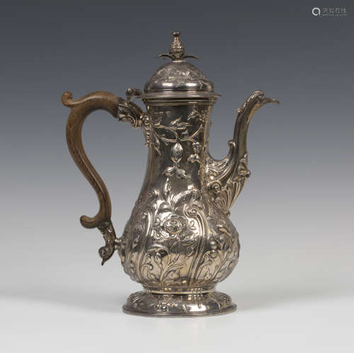 A George III silver coffee pot of baluster form, the domed hinged lid with flower bud finial, the