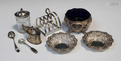 A pair of late Victorian silver circular bonbon dishes, decorated in relief with scrolls,