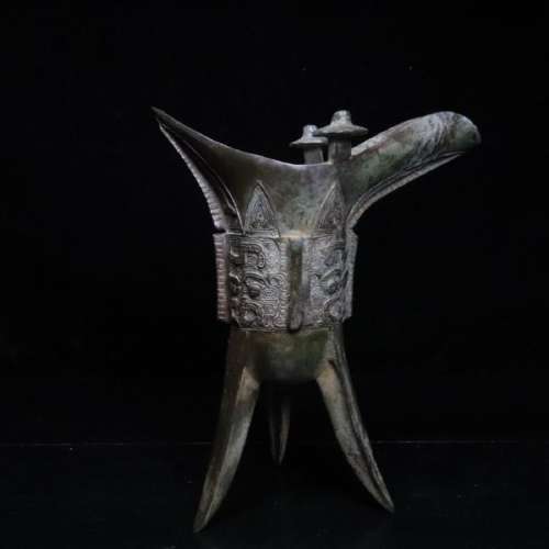 A BRONZE CASTED TRIPOD CUP
