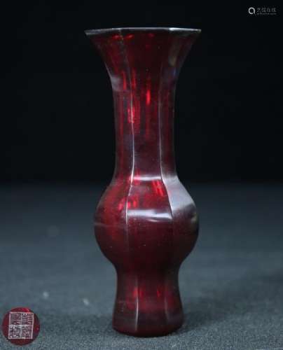 A RED GLASS CASTED VASE