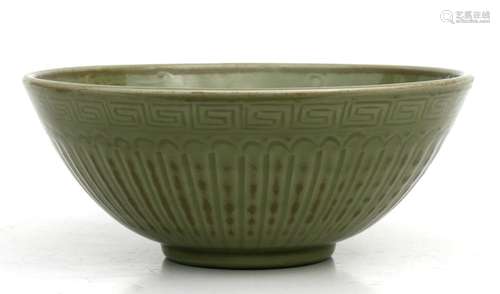 A Chinese celadon glazed bowl decorated with foliate scrolls, 29cms (11.5ins) diameter.