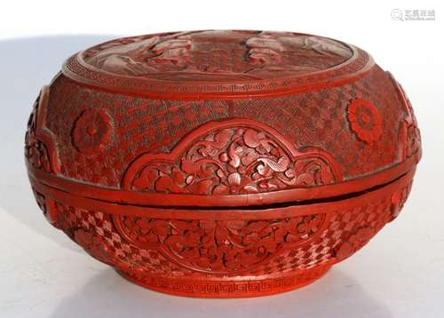 A Chinese cinnabar lacquer box & cover of compressed globular form, decorated with flowers and