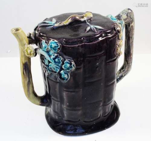 A 19th century Chinese Fahua Cadogan tea pot decorated with flowers on an aubergine ground, 13cms (