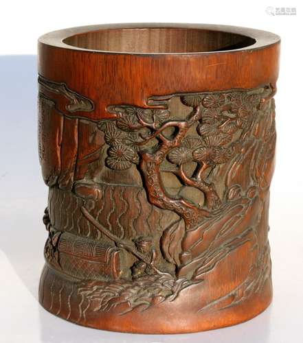 A Chinese bamboo brush pot, deeply carved with boats and figures on a shoreline and calligraphy,