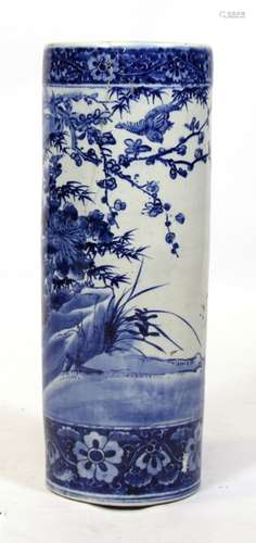 A Chinese blue & white cylindrical stick stand decorated with birds and foliage, 62cms (24.5ins)