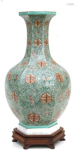 A Chinese hexagonal form vase decorated with blossom and foliate scrolls, on a hardwood stand, 38cms